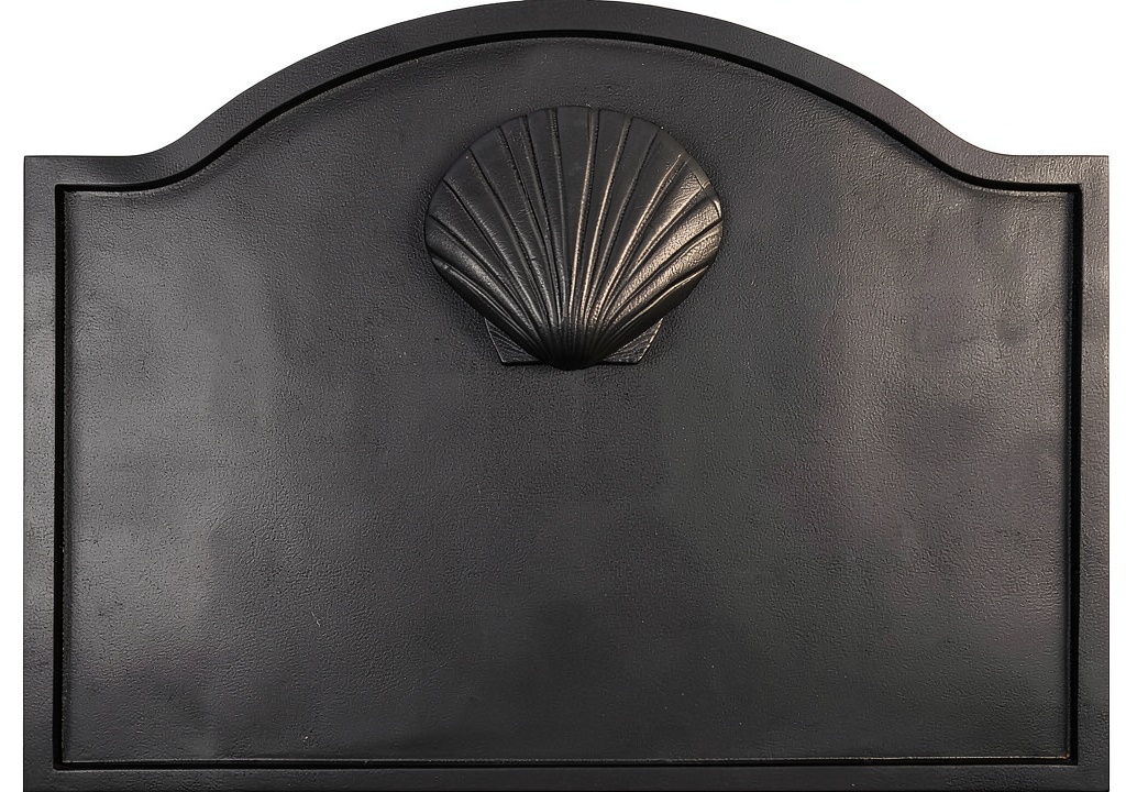 Minuteman fireback installed on a traditional stone fireplace